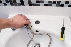 Plumber repairing a faucet